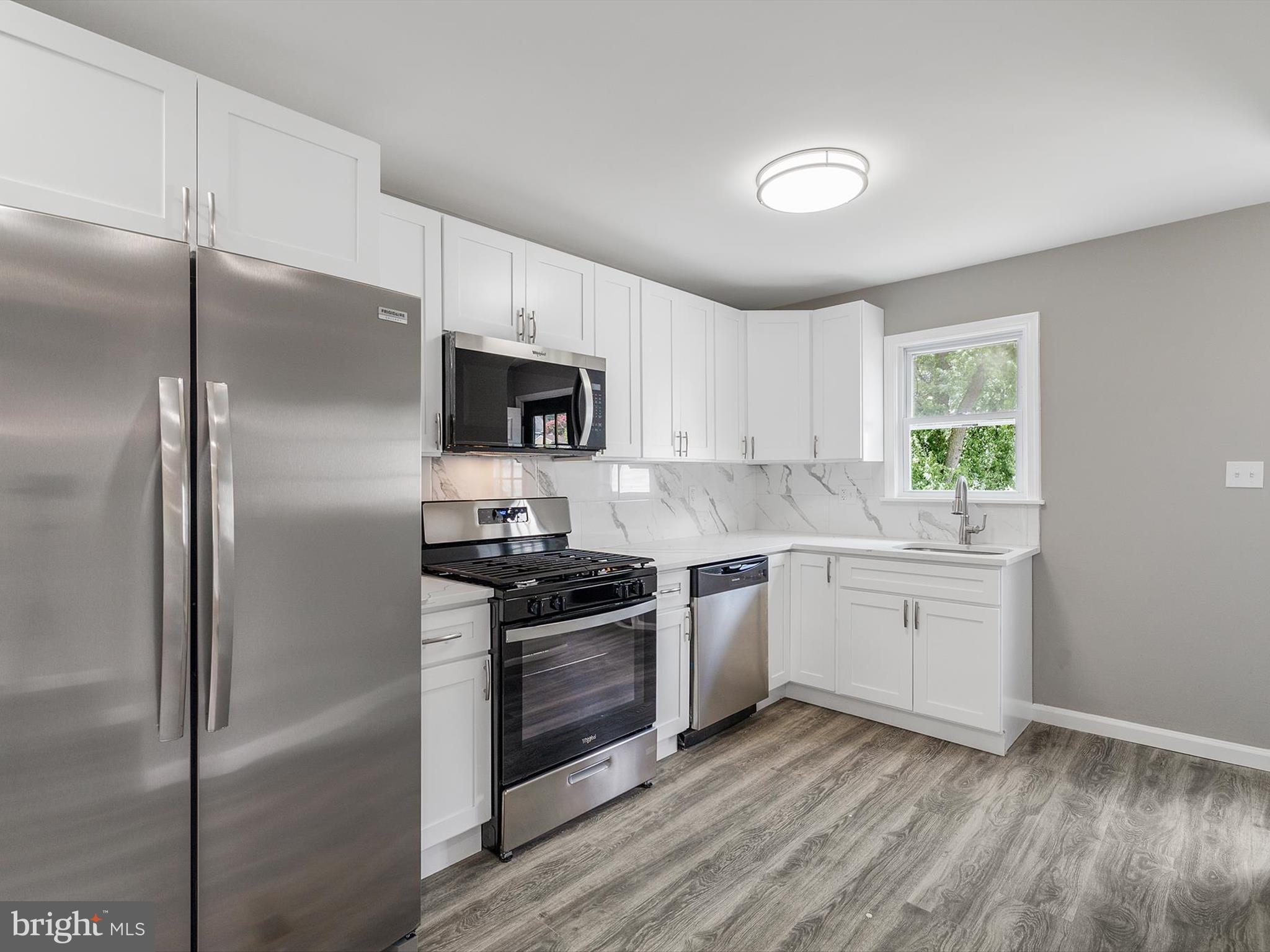 25 Mansion Road Linthicum Heights, MD 21090 - Photo 8 of 26 a kitchen with a refrigerator stove and microwave