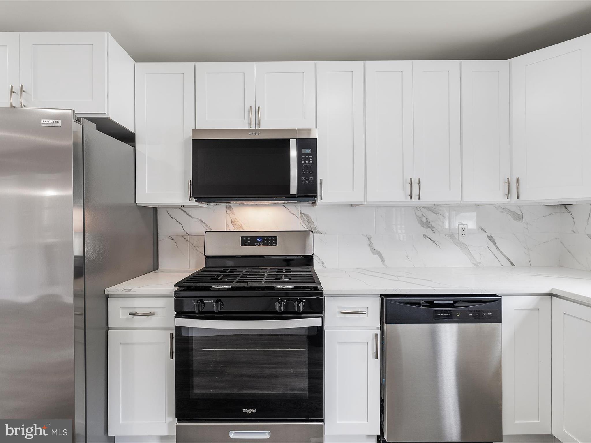 25 Mansion Road Linthicum Heights, MD 21090 - Photo 10 of 26 a kitchen with stainless steel appliances a refrigerator a stove a microwave and cabinets