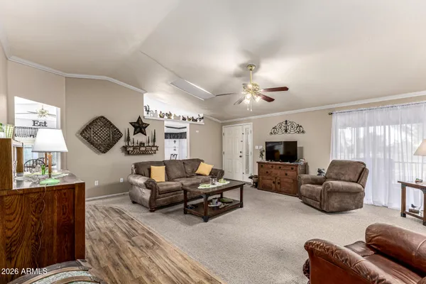 a living room with furniture flat screen tv and window
