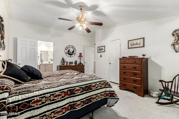 a bedroom with a bed and a chandelier