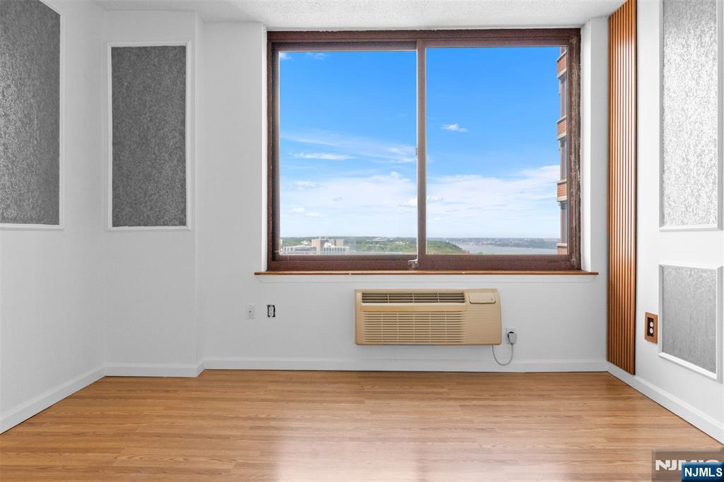 100 Old Palisade Road, Unit 3215 Fort Lee, NJ 07024 - Photo 22 of 43 a view of an empty room with wooden floor and a window