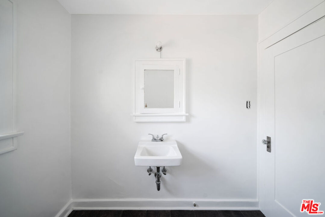 2346 Ridgeview Avenue Los Angeles, CA 90041 - Photo 12 of 22 a bathroom with a sink a mirror and a lamp