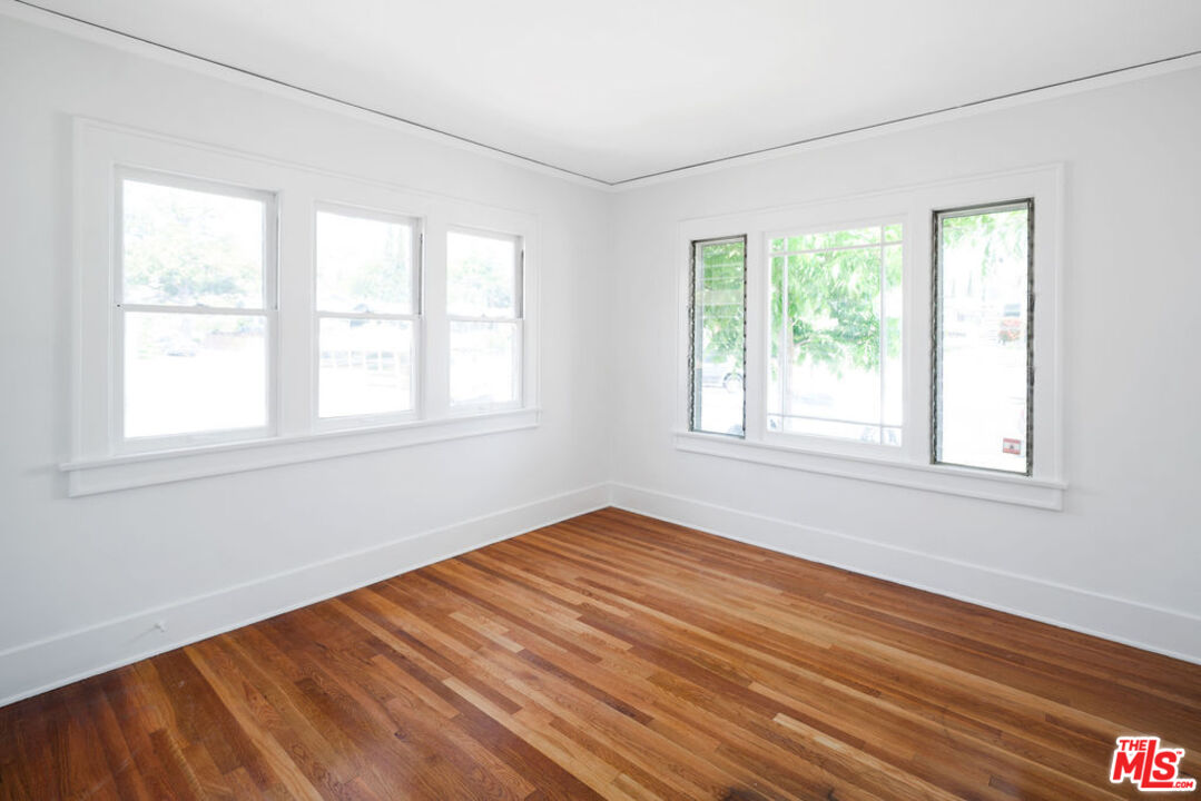 2346 Ridgeview Avenue Los Angeles, CA 90041 - Photo 13 of 22 an empty room with wooden floor and windows