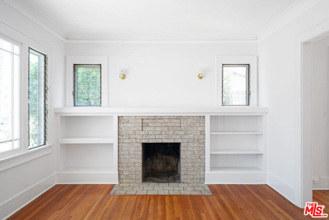 2346 Ridgeview Avenue Los Angeles, CA 90041 - Photo 3 of 22 a view of a livingroom with wooden floor and a fireplace