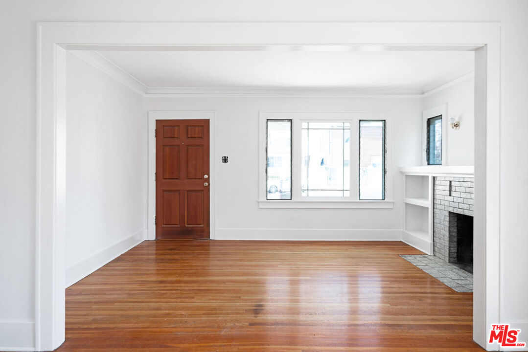 2346 Ridgeview Avenue Los Angeles, CA 90041 - Photo 5 of 22 a view of empty room with wooden floor and fireplace