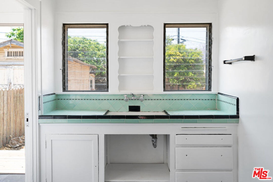 2346 Ridgeview Avenue Los Angeles, CA 90041 - Photo 8 of 22 a bathroom with a granite countertop sink and a window