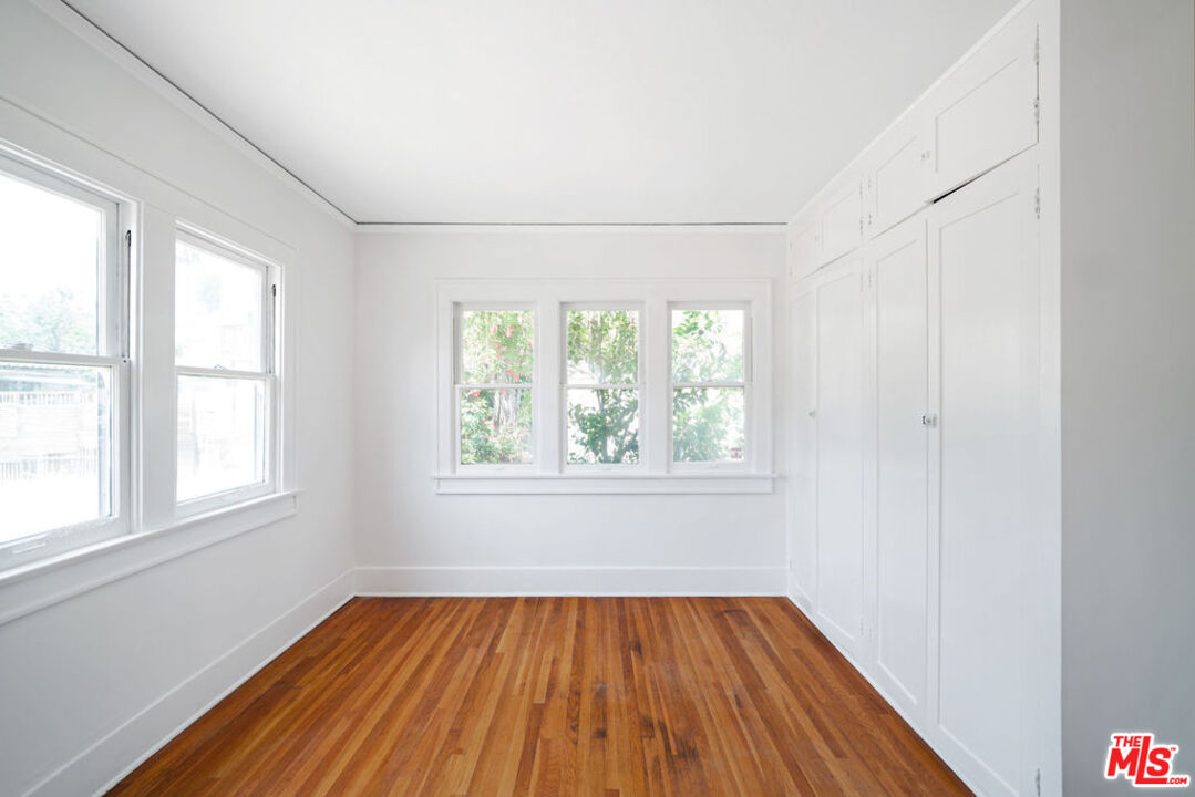 2346 Ridgeview Avenue Los Angeles, CA 90041 - Photo 10 of 22 an empty room with wooden floor and windows