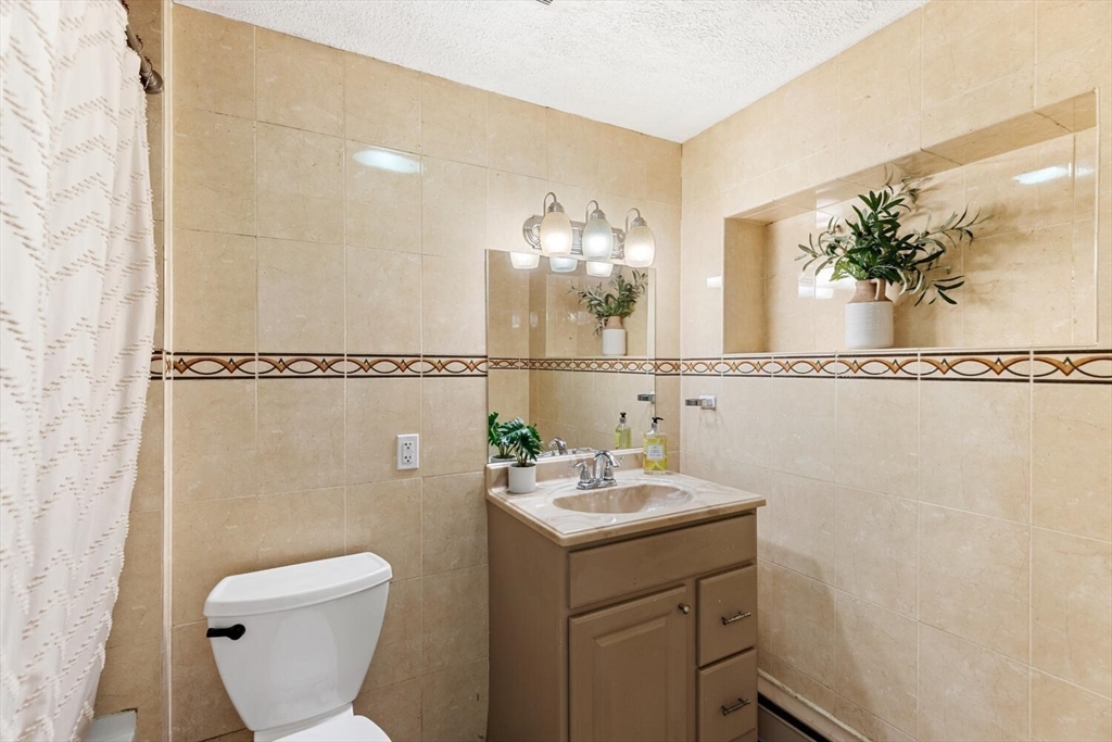 2 McIntyre Road Saugus, MA 01906 - Photo 27 of 42 a bathroom with a sink mirror and toilet