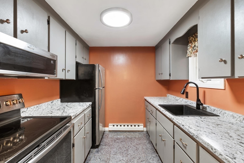 2 McIntyre Road Saugus, MA 01906 - Photo 29 of 42 a kitchen with stainless steel appliances granite countertop a sink stove and refrigerator
