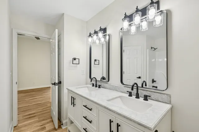 a view of a room with wooden floor and white walls