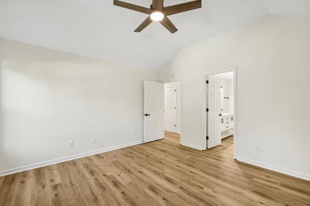 a view of a room with wooden floor and white walls