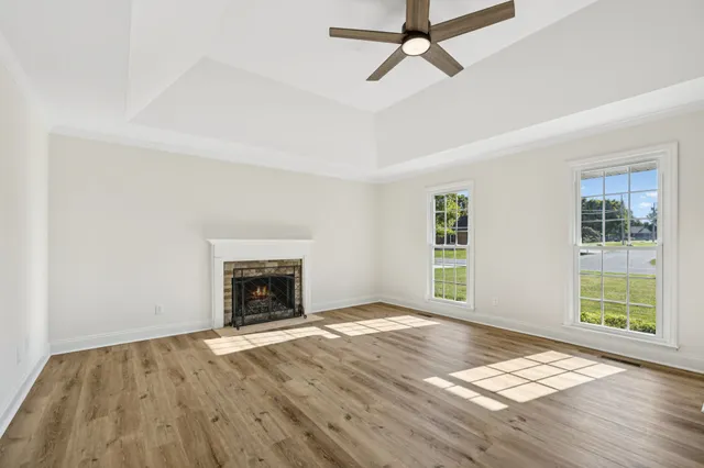 a view of an empty room with a fireplace and a window