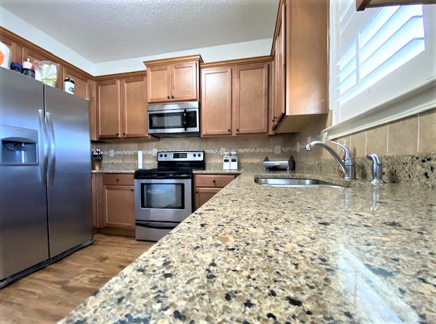 266 Owens Road Fort Mitchell, AL 36856 - Photo 6 of 16 a kitchen with stainless steel appliances granite countertop a stove a sink and a microwave