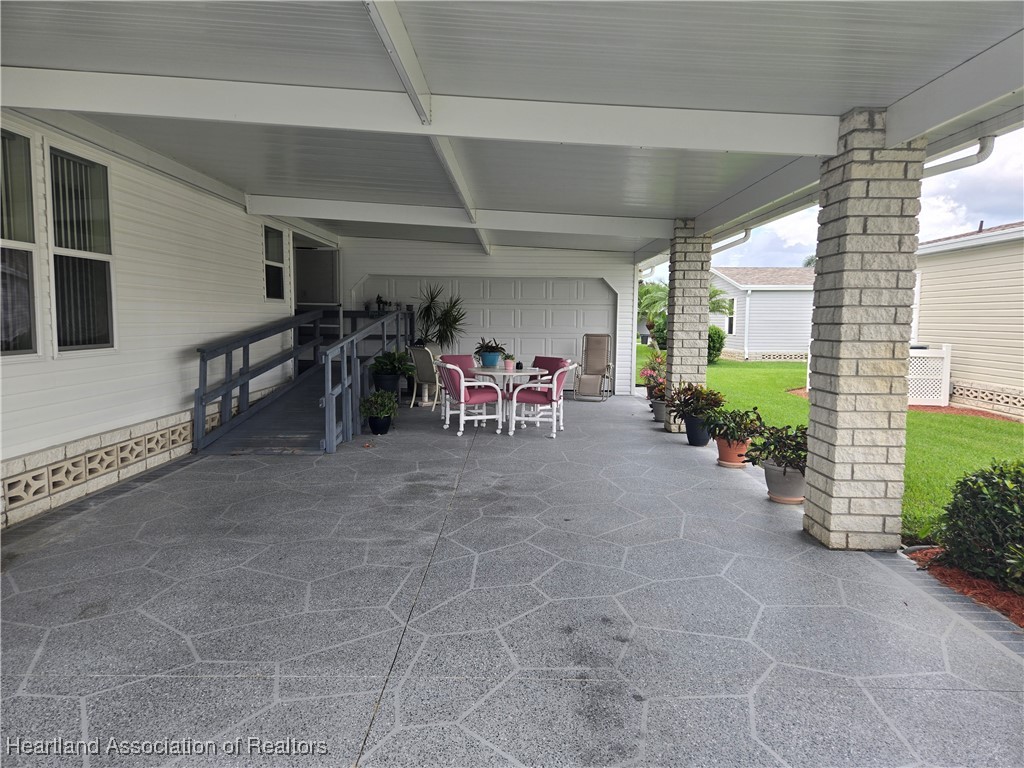 3312 Beartooth Pass Sebring, FL 33872 - Photo 2 of 39 a view of a porch with dining table and chairs