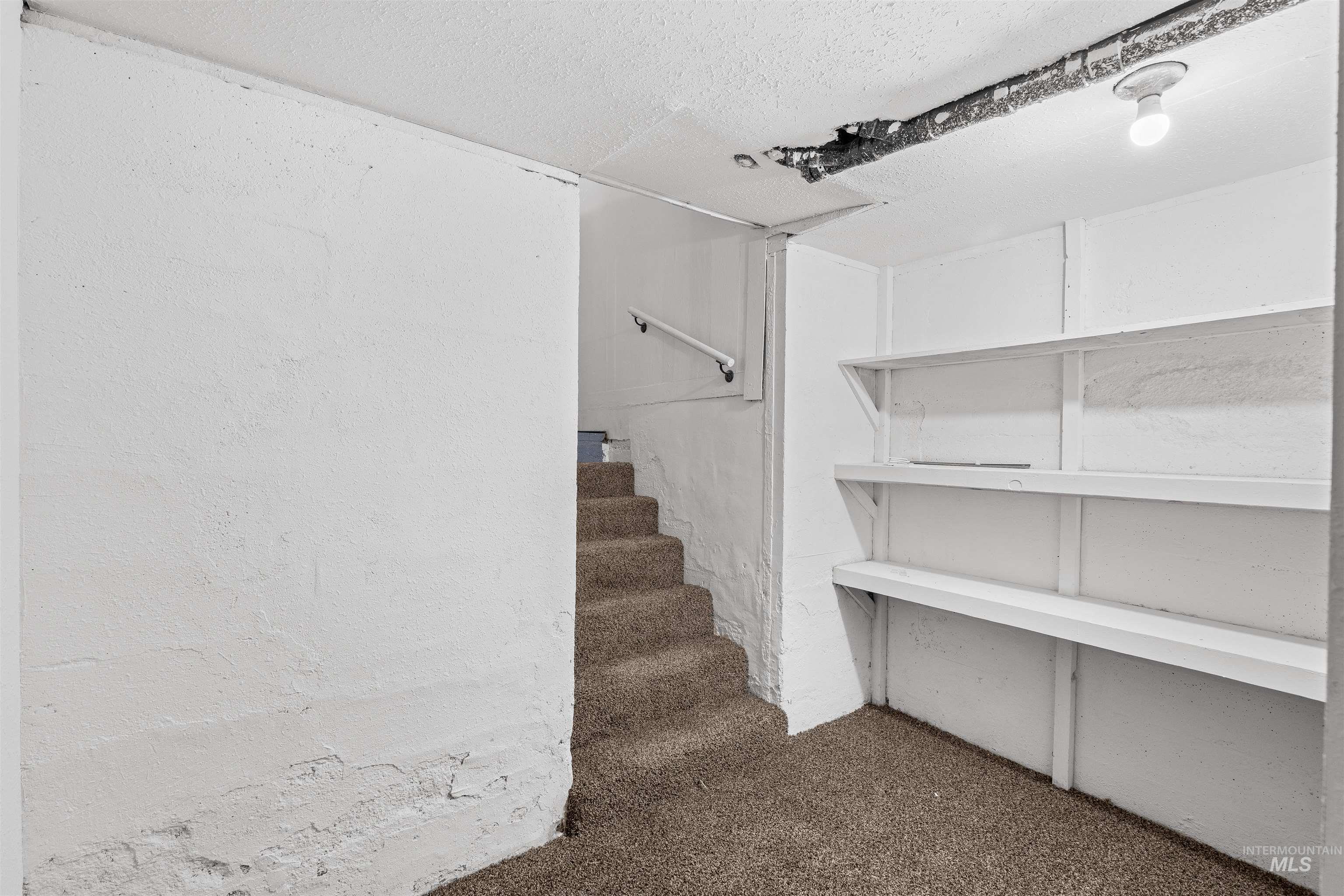 716 7th Street Clarkston, WA 99403 - Photo 25 of 38 Below grade area featuring stairway and a textured ceiling