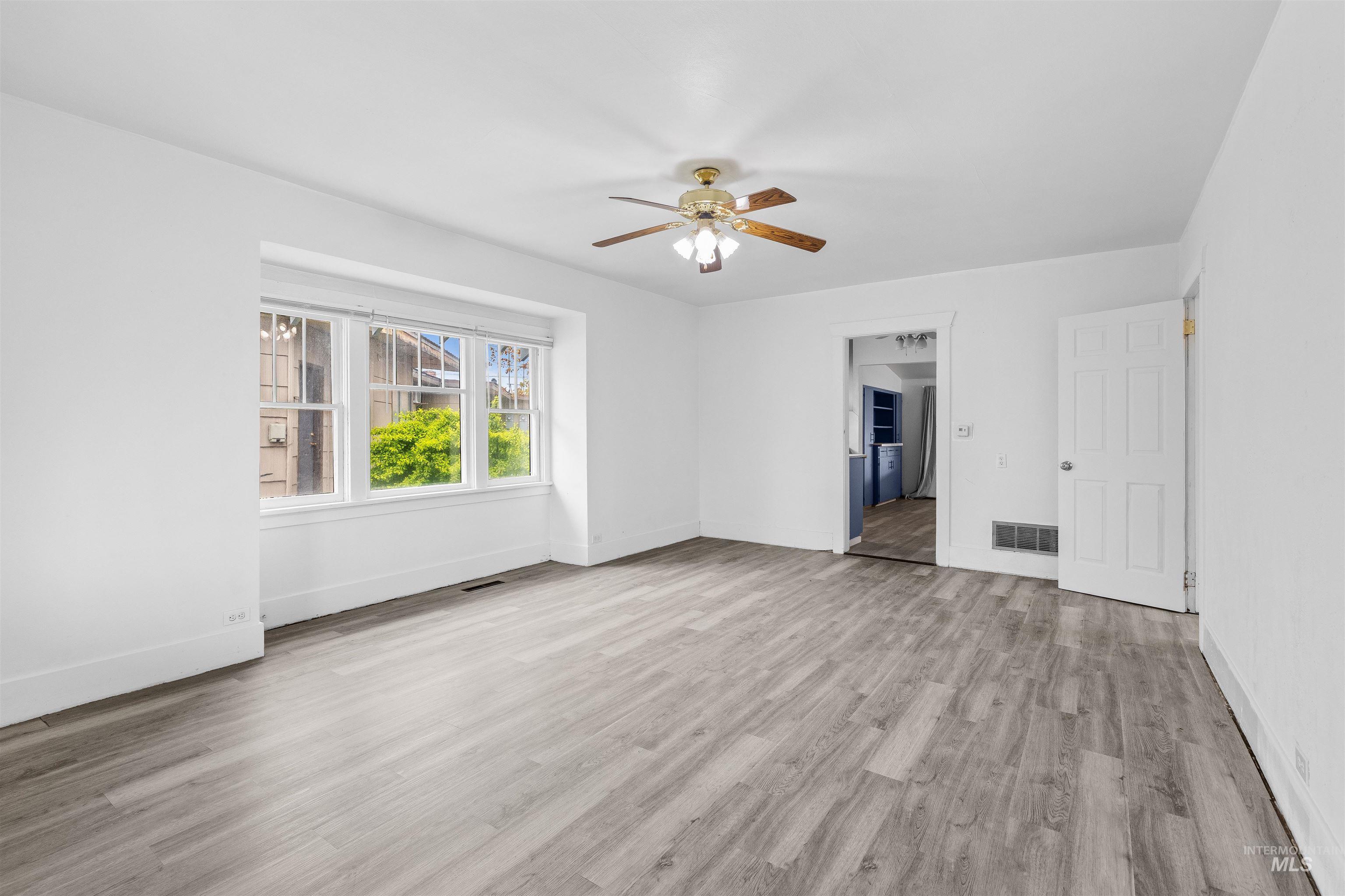 716 7th Street Clarkston, WA 99403 - Photo 3 of 38 Unfurnished living room with a ceiling fan and light wood-style floors