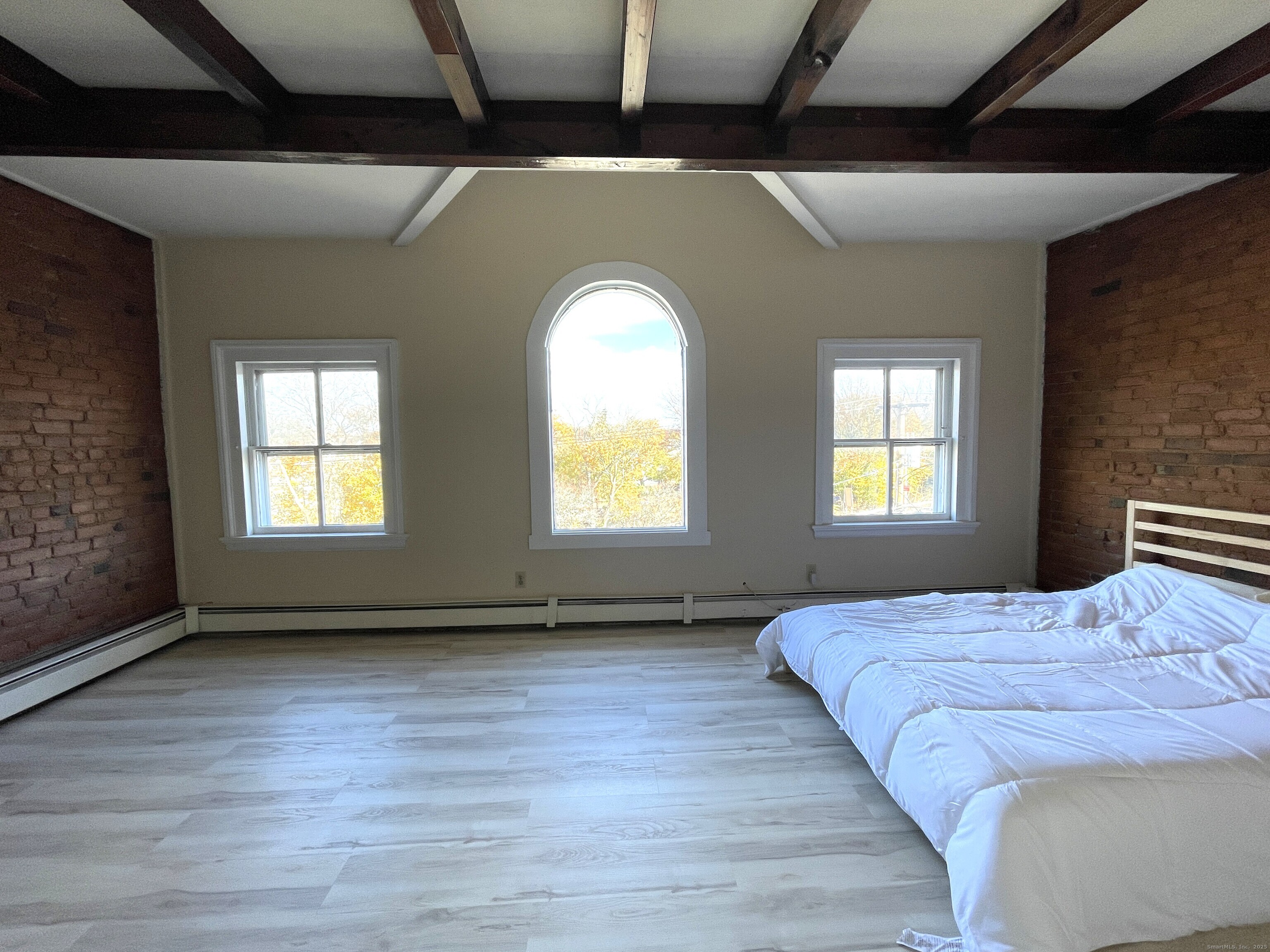32 Trumbull Street, Unit 4 New Haven, CT 06511 - Photo 2 of 6 a bedroom with a bed and a window