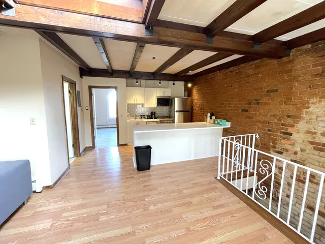 a view of a porch with wooden floor