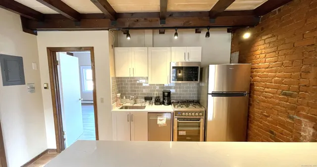a kitchen with stainless steel appliances a refrigerator and a stove