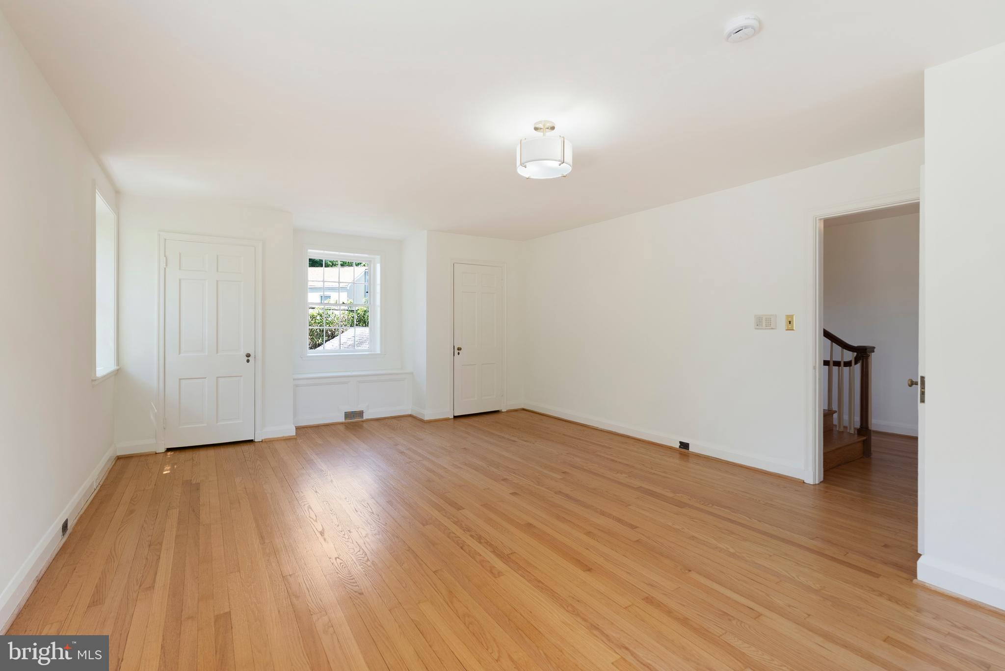 602 Stoneleigh Road Baltimore, MD 21212 - Photo 14 of 31 an empty room with wooden floor and a window