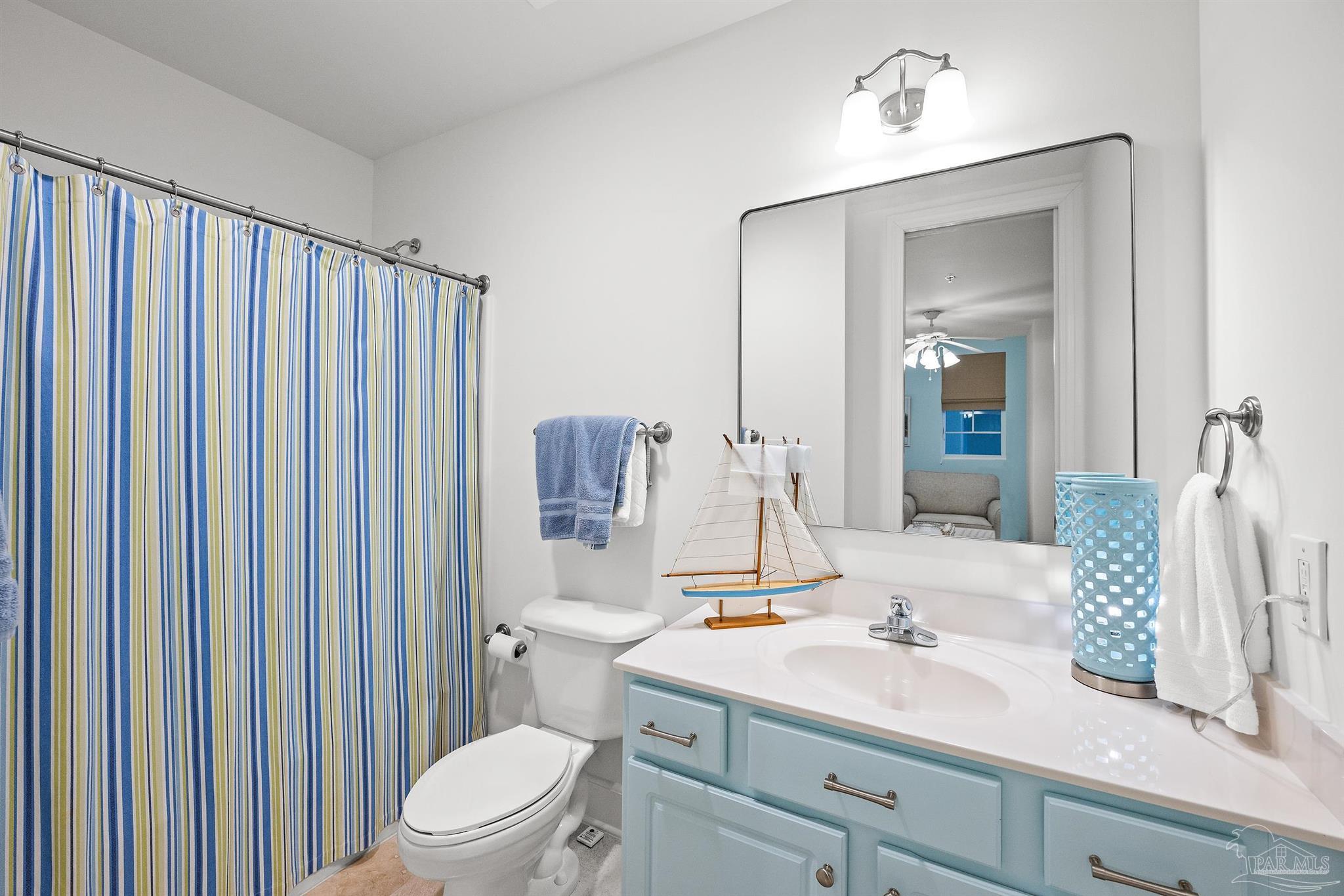 13928 River Road, Unit 204 Pensacola, FL 32507 - Photo 24 of 36 a bathroom with a granite countertop sink vanity mirror and toilet