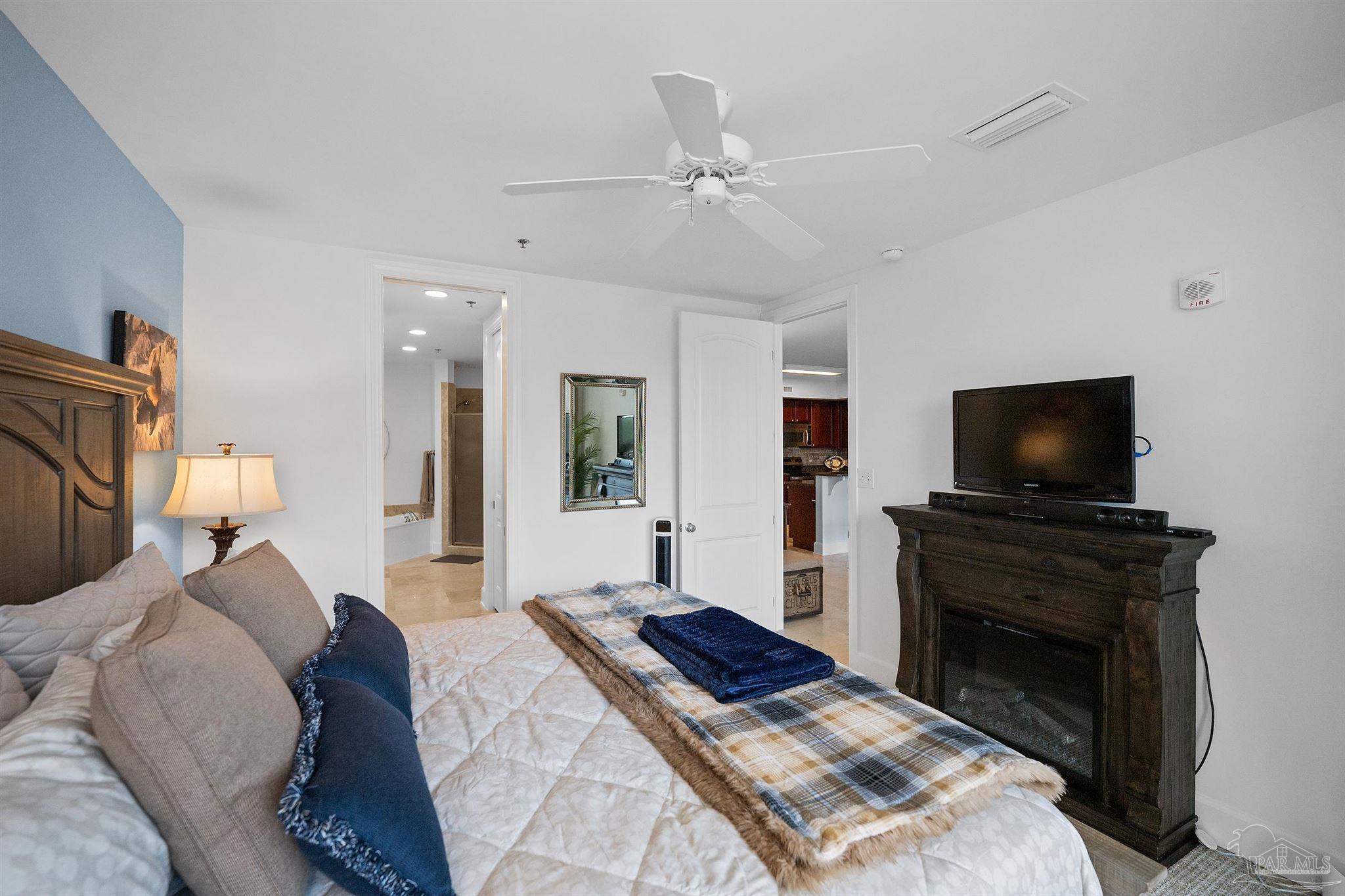 13928 River Road, Unit 204 Pensacola, FL 32507 - Photo 26 of 36 a bedroom with a bed and a flat screen tv