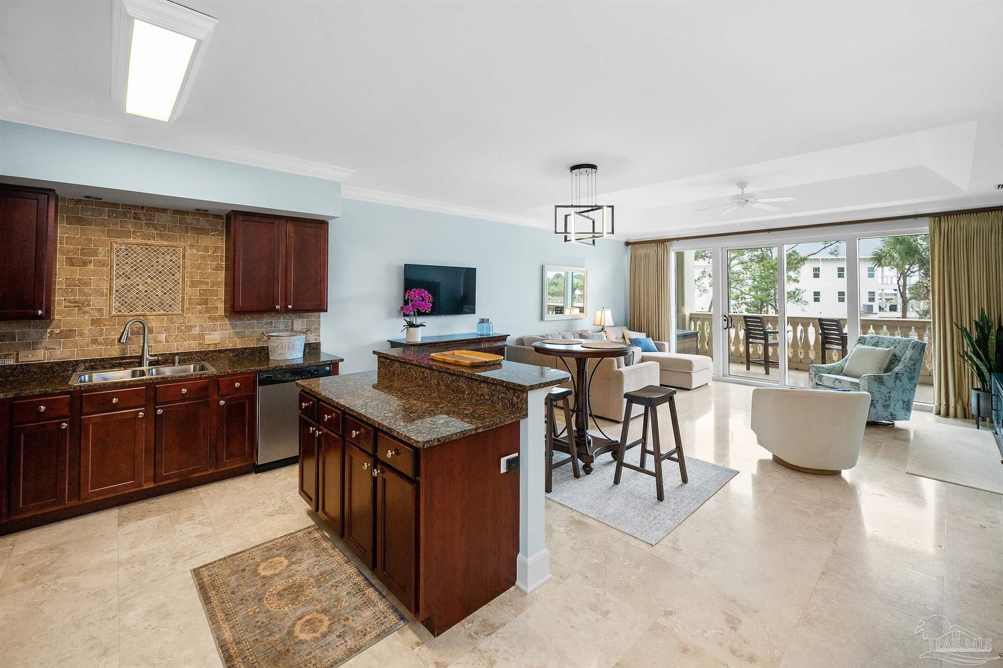 13928 River Road, Unit 204 Pensacola, FL 32507 - Photo 8 of 36 a kitchen with granite countertop a stove top oven a sink dishwasher a dining table and chairs with wooden floor