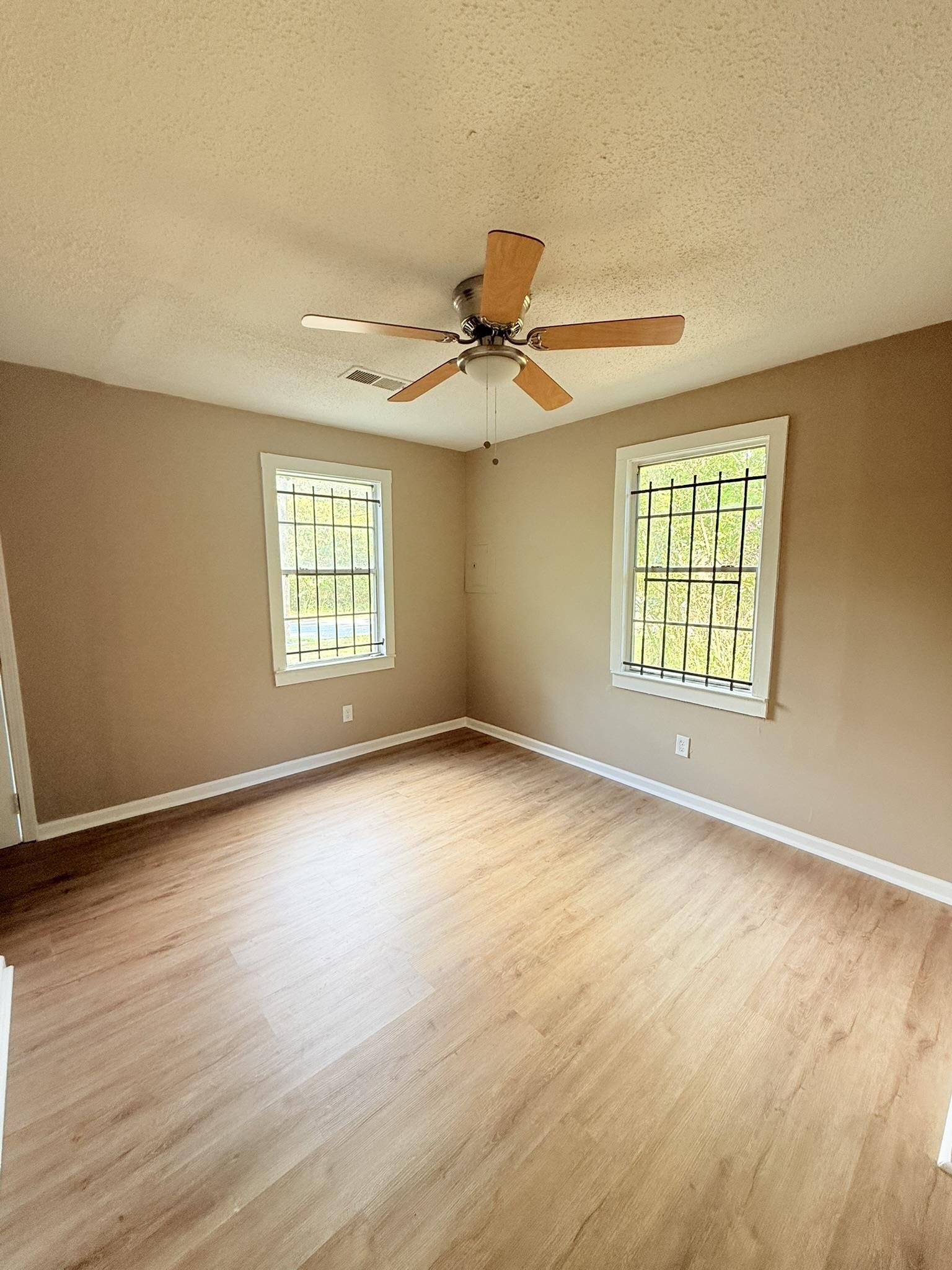 931 Calvin Road Memphis, TN 38109 - Photo 6 of 15 wooden floor in an empty room with a window