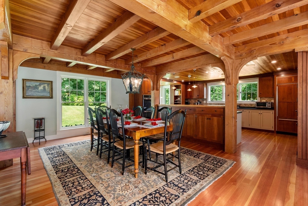 61 Dutton Road Sudbury, MA 01776 - Photo 16 of 42 a dining room with furniture a rug and wooden floor