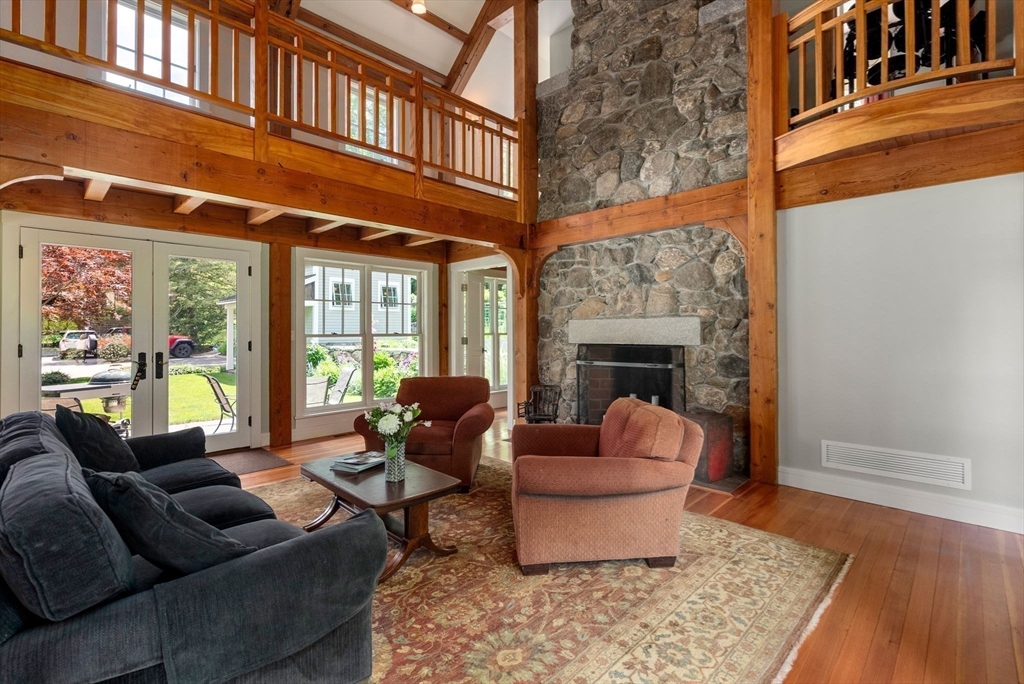 61 Dutton Road Sudbury, MA 01776 - Photo 17 of 42 a living room with furniture fireplace and a table