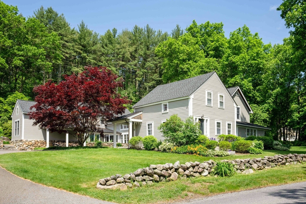 61 Dutton Road Sudbury, MA 01776 - Photo 2 of 42 a front view of a house with a garden