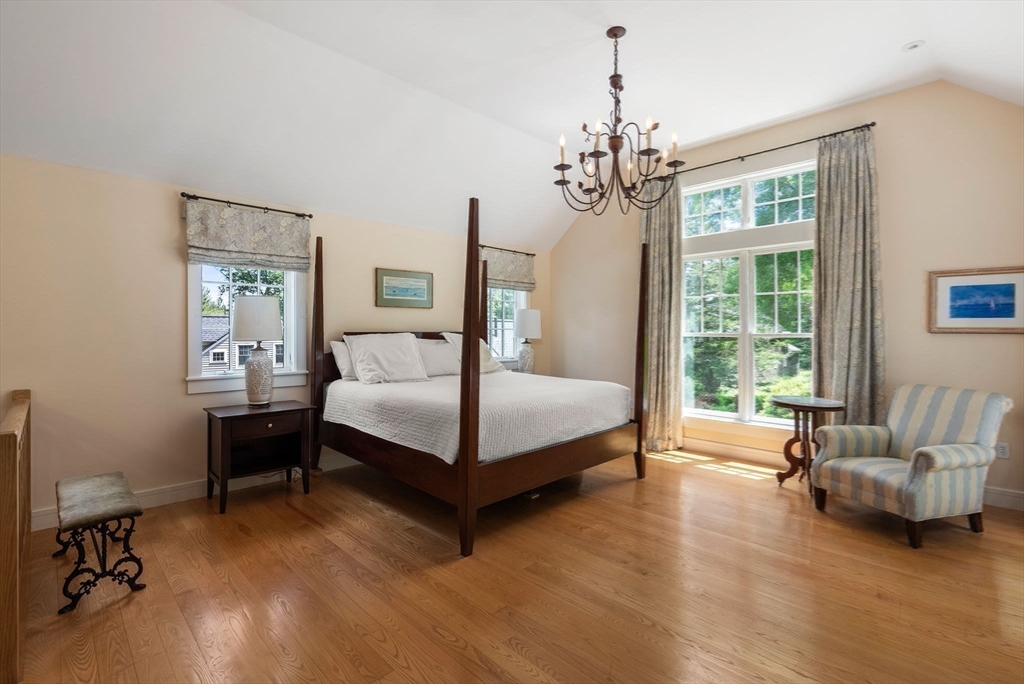 61 Dutton Road Sudbury, MA 01776 - Photo 29 of 42 a bedroom with a bed chandelier and windows
