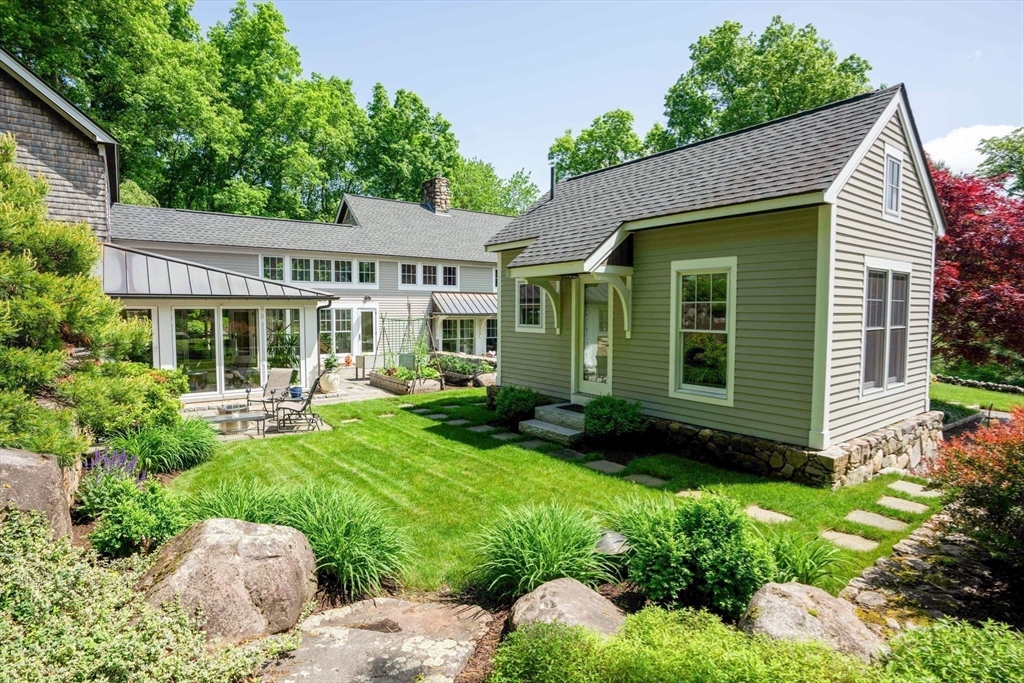 61 Dutton Road Sudbury, MA 01776 - Photo 36 of 42 a view of a house with a yard and plants