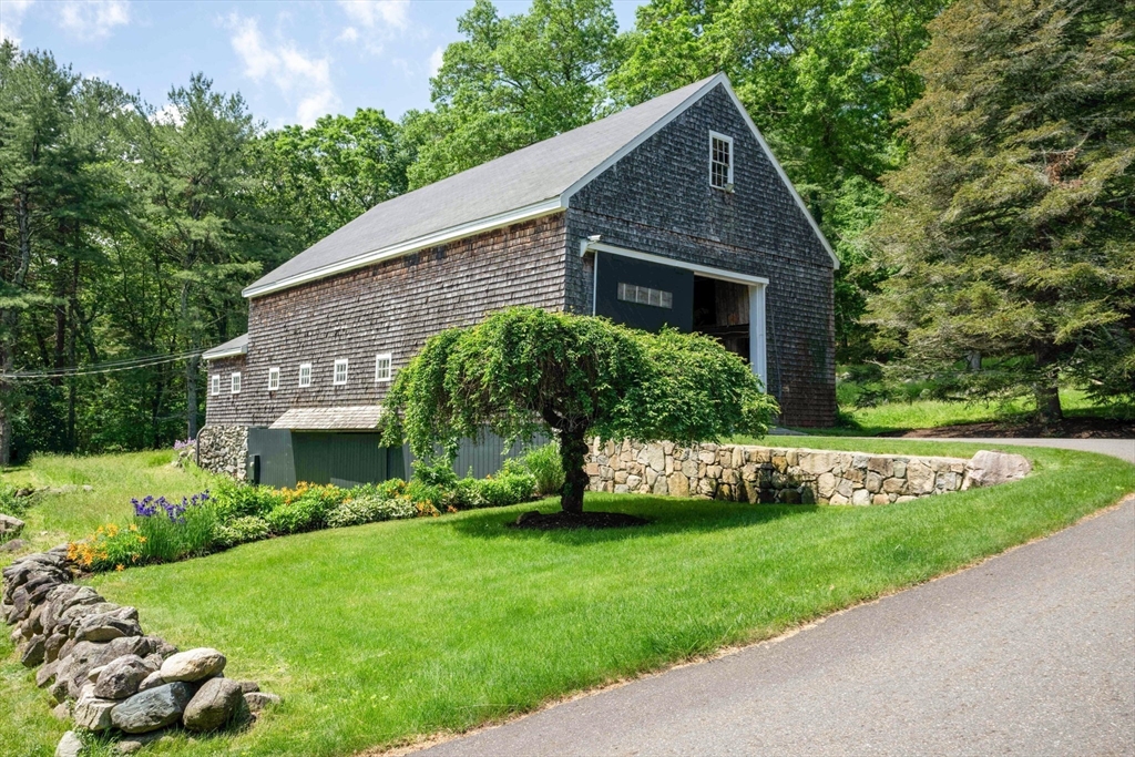 61 Dutton Road Sudbury, MA 01776 - Photo 4 of 42 a front view of a house with a yard and potted plants