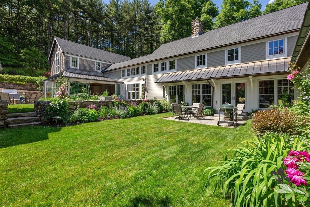 61 Dutton Road Sudbury, MA 01776 - Photo 42 of 42 a front view of a house with swimming pool and chairs