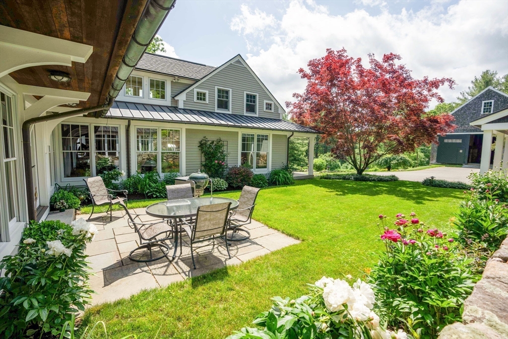 61 Dutton Road Sudbury, MA 01776 - Photo 6 of 42 a view of a house with backyard sitting area and garden