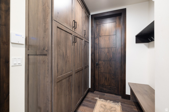 11547 Soaring Hawk Lane Hideout, UT 84036 - Photo 34 of 43 Extensive wood-finish built-in cabinetry with black hardware, complementing a dark wood-finish door with modern paneling
