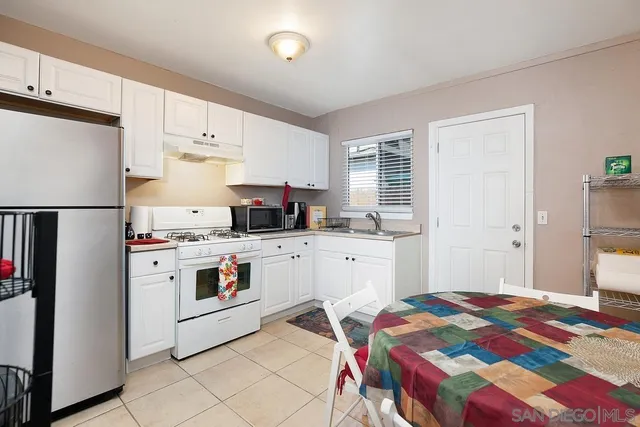 a kitchen with a appliances a sink and a refrigerator