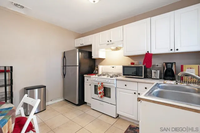 a kitchen with cabinets and appliances