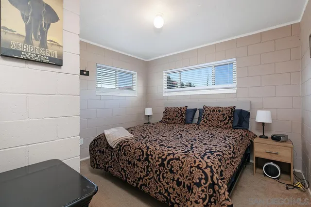 a bedroom with a bed and a couch