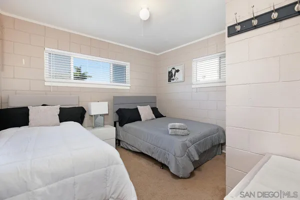 a bedroom with two beds and a window