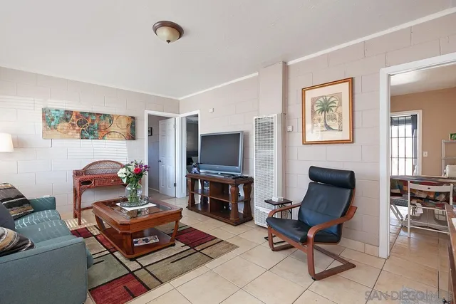 a living room with furniture a flat screen tv and a fireplace