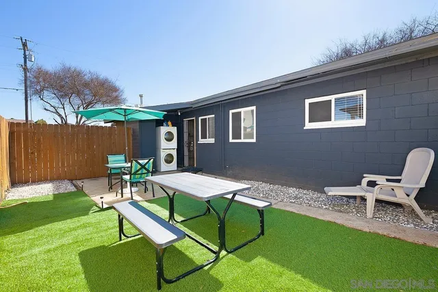 a patio with table and chairs