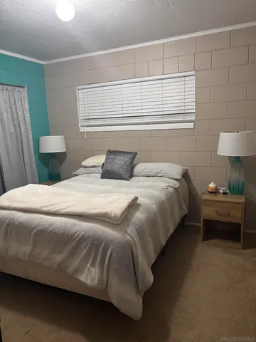 a bedroom with a bed and a lamp