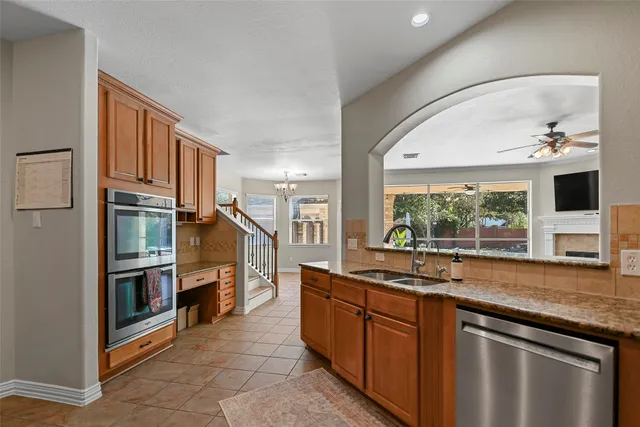 a kitchen with stainless steel appliances granite countertop a stove and a refrigerator