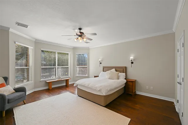 a spacious bedroom with a bed and glass window