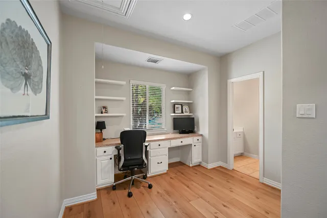 a view of a workspace with wooden floor and a workspace