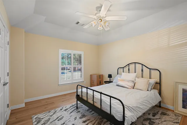 a bedroom with a large bed and a chandelier