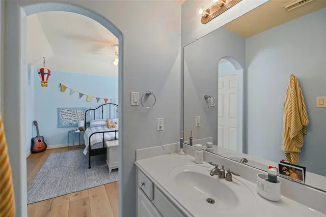 a en suite bathroom with a double vanity sink and a mirror