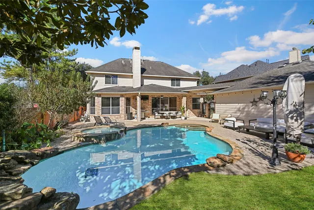 a front view of a house with swimming pool having outdoor seating